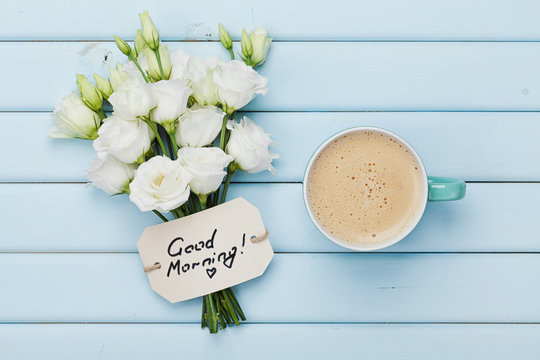 Coffee Mug With White Flowers And Notes Good Morning On Blue Rustic Table From Above. Beautiful Breakfast. Flat Lay.