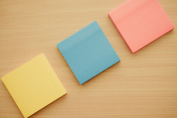 Color block of paper notes on wooden background