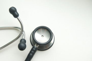 Black stethoscope on a white desk