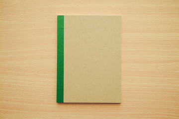 Blank notepad or notebook on wooden background - Business and education concept.