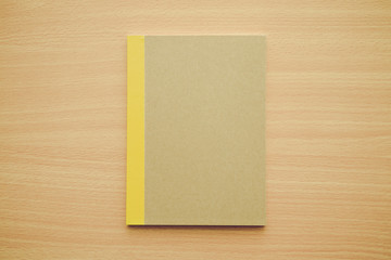 Blank notepad or notebook on wooden background - Business and education concept.