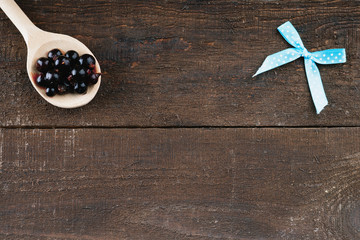 Wooden spoon with blueberries and bow