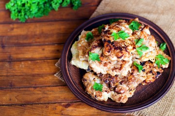 Juicy delicious meat cutlets on a wooden table in a rustic style.
