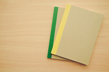 Blank notepad or notebook on wooden background - Business and education concept.