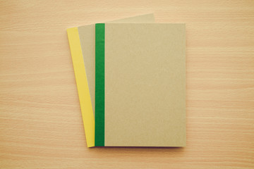 Blank notepad or notebook on wooden background - Business and education concept.