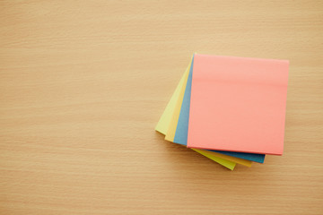 Color block of paper notes on wooden background