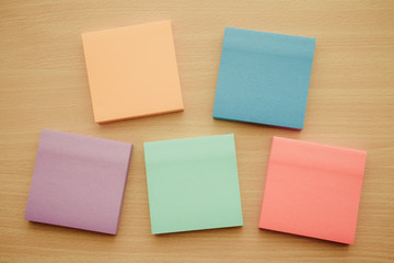 Color block of paper notes on wooden background