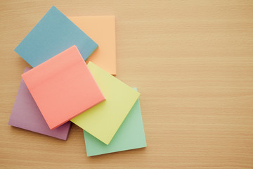 Color block of paper notes on wooden background