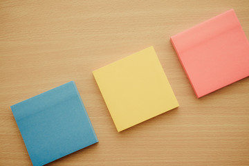 Color block of paper notes on wooden background