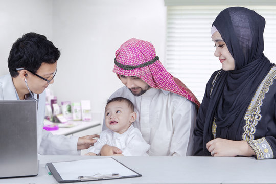 Arabic little boy visit doctor with his parents