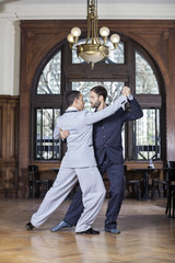 Partners Performing Argentine Tango In Restaurant