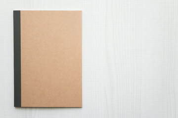 Blank empty notepad on white wooden background - Business and education concept.