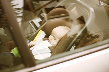 Fototapeta na wymiar Baby forgotten alone in the car in a really hot day 