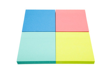 Four color block of paper notes isolated white background.