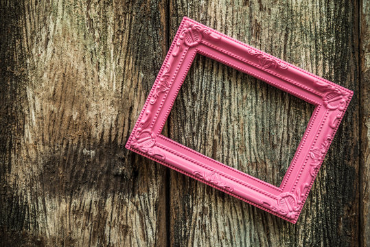 Vintage Pink Photo Frame On Old Wooden Background