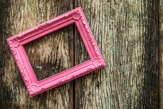 Vintage Pink Photo Frame On Old Wooden Background