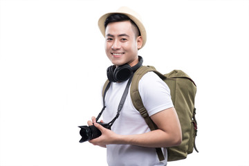 Travel concept. Studio portrait of handsome young man in hat wit