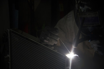 Thai people use electricity welding for fix and solder radiator