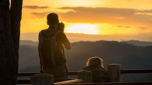 Couple Watching Sunset Mountain Outdoors Concept
