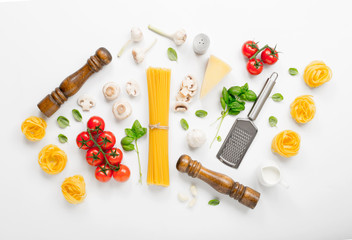 Fettuccine and spaghetti with ingredients for cooking Italian pa