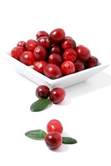 Cranberry with leaf on white background.  