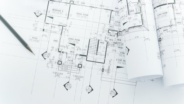 architects workplace - architectural blueprints with measuring tape, safety helmet and tools on table. top view 