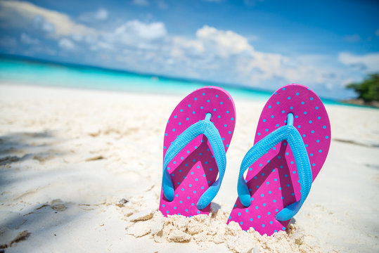 Pink beach flip flop on beautiful tropical island beach summer holiday - Travel summer vacation concept.	