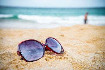Fototapeta na wymiar Sunglasses on beautiful tropical island beach summer holiday - Travel summer vacation concept. 