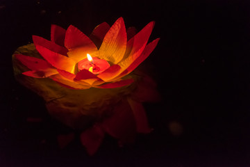Floating paper lanterns on the water at night