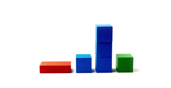 Time lapse of ecology business concept. Red wooden toy is suggesting the decrease, blue cubes grow and green cubes maximum growth. All is isolated on the white background.