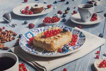Pastry pie, tea, coffee and berries at blue rustic wood