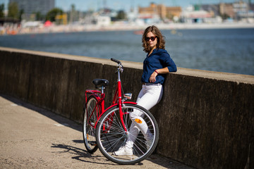 Urban biking - young woman and bike in city
