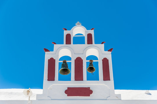White and red bells tower in Santorini