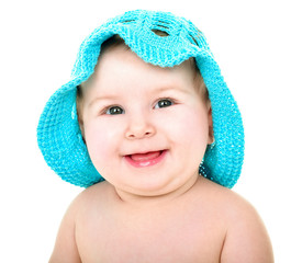 Beautiful happy baby in blue hat. . One,isolated on white.