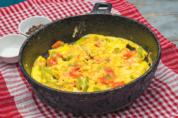 Omelet with vegetables in pot.
