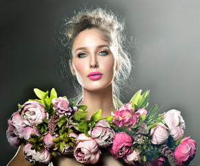 Beautiful  fashion  Model woman with Blooming flowers. Bouquet o