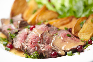 Tasty roasted pork meat with potatoes