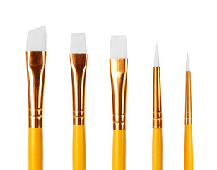 close up of paint brushes on white background