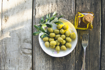 dish of olives on wooden background