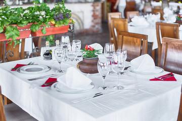 Glasses and plates on table in restaurant