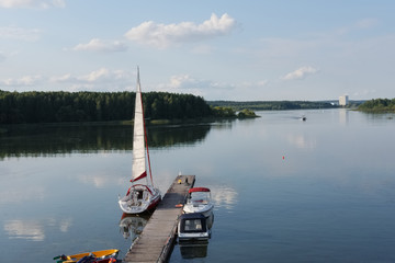 Yacht moored to the lake pier. A view of space with docked yacht