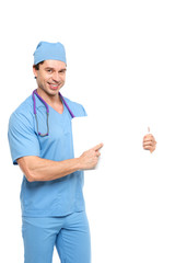 Confident male nurse holding a sign for your text on white.