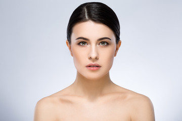 Darkhaired girl with nude make up at studio