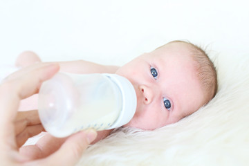 baby drinking milk from bottle
