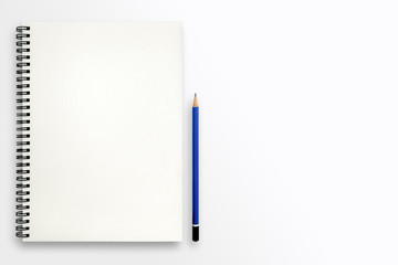 Open blank sketchbook and pencil on white background