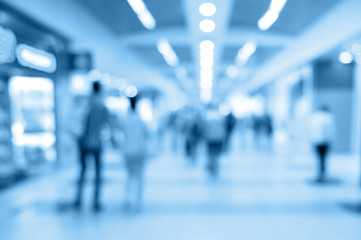Blurred background of airport corridor toned in blue