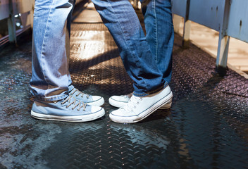 People and relationships. Closeup of young couples feet on a city bridge.  © kieferpix