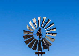 Multibladed windpump head against blue sky