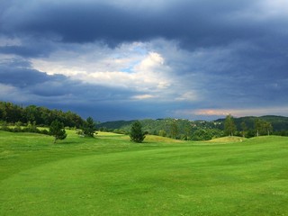 Fototapeta na wymiar On a empty golf course before storm