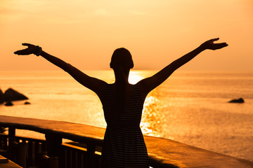 Happy woman enjoying the sunset. 